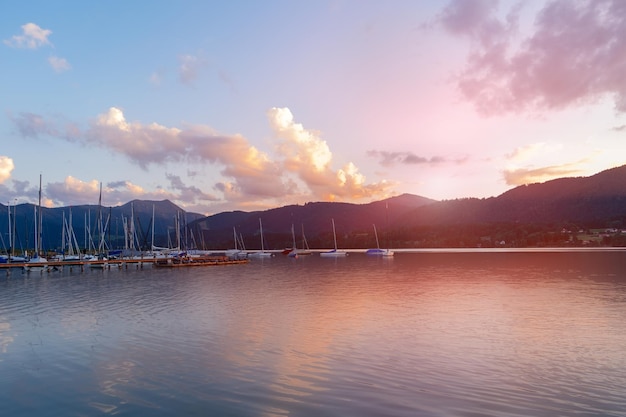 XDxALake and yachts against the backdrop of a mountain landscape at sunset