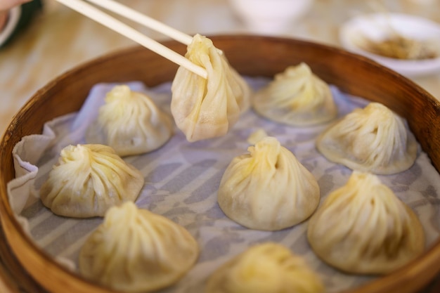 Xiao long bao soup dumpling buns with chopsticks in restaurant Traditional Chinese food in Taipei Taiwan