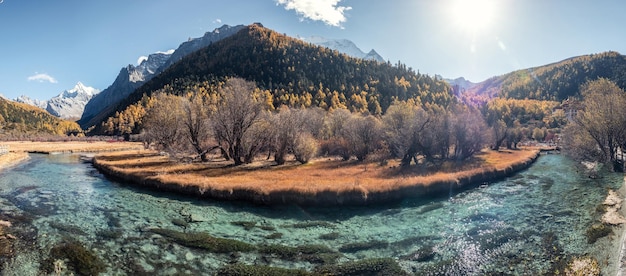 Xiaoduo holy mountain with Chonggu temple with emerald river in autumn forest