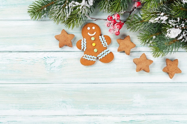 Xmas greeting card Christmas background with snow fir tree and gingerbread cookies View from above with space for your greetings