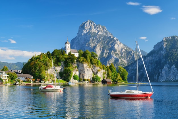 A yacht against the backdrop of mountains and an old castle in Switzerland A popular place to travel and relax xA