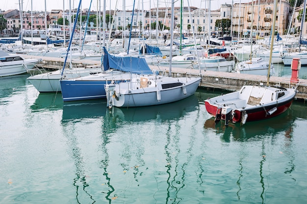 Yacht parking in harbor, harbor yacht club, Italy. Beautiful Yachts in blue sky 