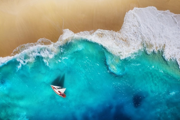 Yacht on the sea from top view Turquoise water background from top view Beach and waves Summer seascape from air Travel image