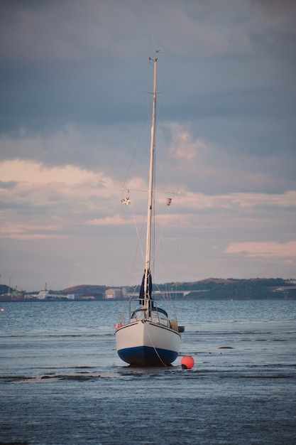 Yacht standing on the shallows in the background of the firth of forth at sunset scotland