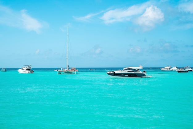 Yachts or sailboats sailing on beautiful turquoise sea water surface