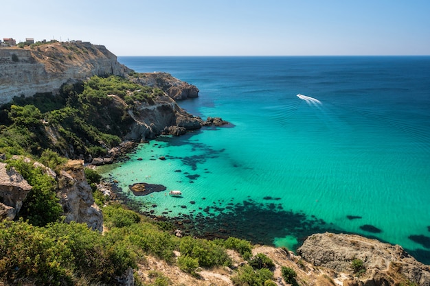 Yachts at sea in a rocky lagoon