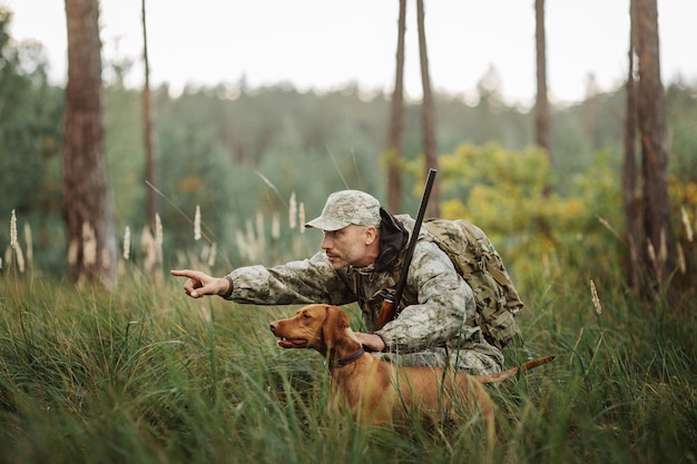 Yang Hunter with Rifle and Dog in forest