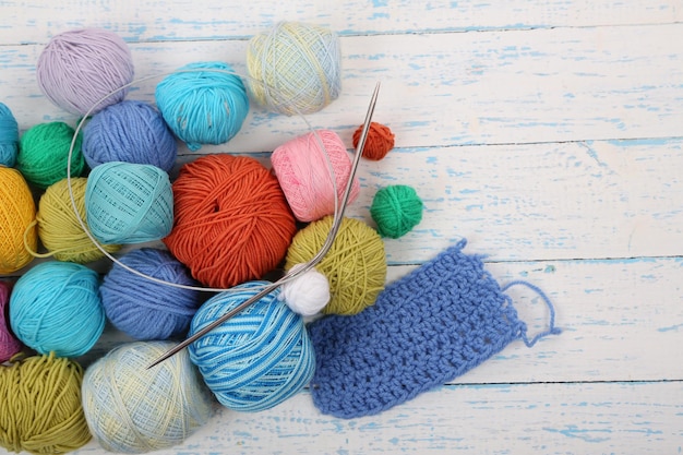 Yarns for knitting on wooden table closeup