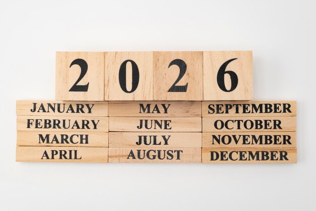 Photo year 2026 written on wooden cubes on top of the months of the year