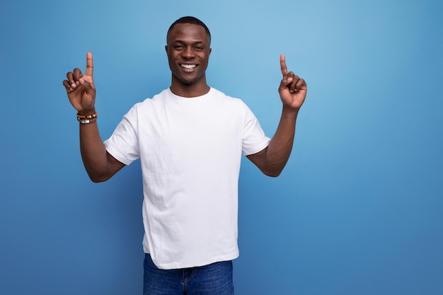 year old american male adult in a white tshirt shows with his hand for an idea and a suggestion