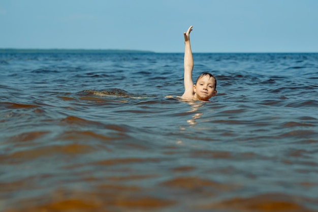 Years old cute caucasian boy swimming in the sea