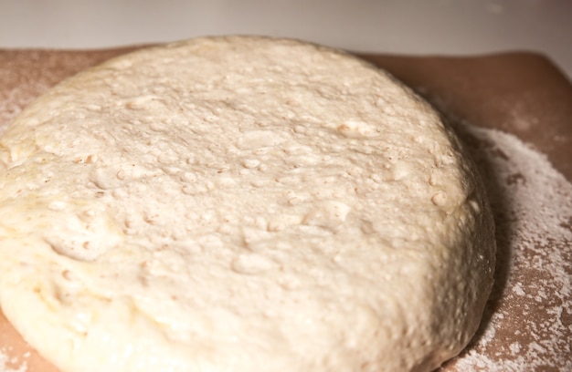 Yeast dough on the table. Baking concept. Cooking ideas. Homemade food. Knead flour and water.