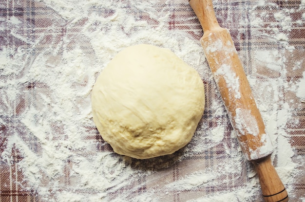 Yeast dough on the table. Cooking baking. Selective focus.