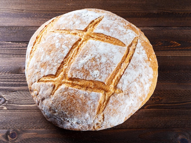 Yeastfree sourdough bread lying on a wooden background View from above