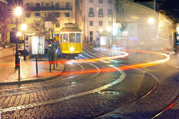 Yellow 28 tram in Alfama at night Lisbon Portugal