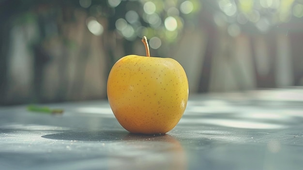 a yellow apple is on a table with a blurred background