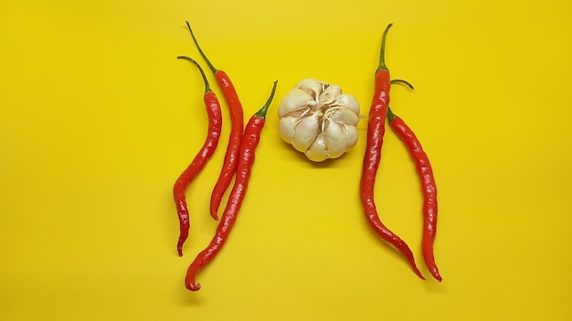 a yellow background with a head of garlic and a head of garlic