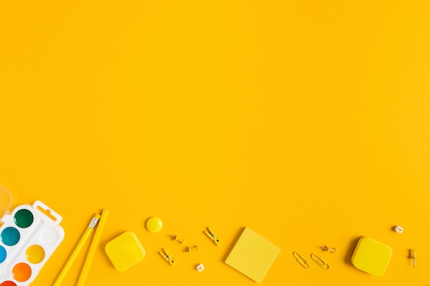 Yellow background with school supplies