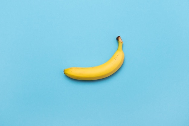 Yellow banana on pastel blue background Minimal fashion flatlay