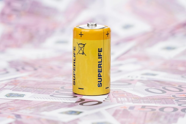 Yellow Battery stands on the money nominal value of five hundred euro