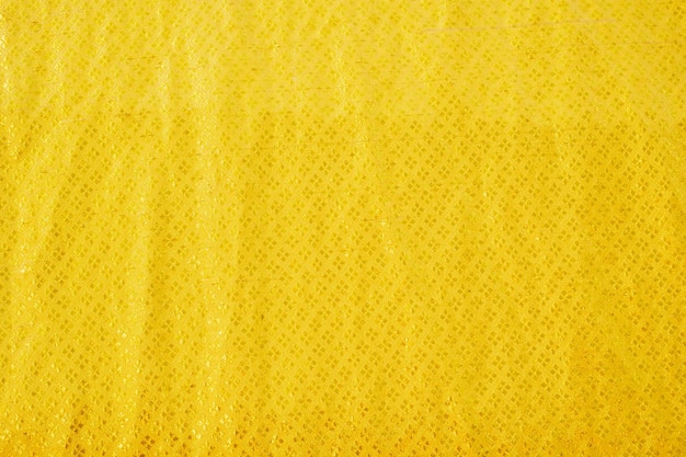 Yellow bed linen gradient texture blurred curve style of abstract luxury fabricWrinkled bed linen and gold shadowsbackground