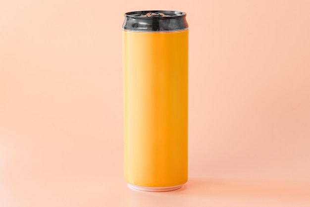 A yellow and black blank aluminum can of beer or energy drink stands on an orange background Mark Advertising Advertise Drinking Dairy Distillery Factory Drinker Production