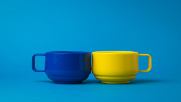 Yellow and blue cups on a blue background. The color trend.