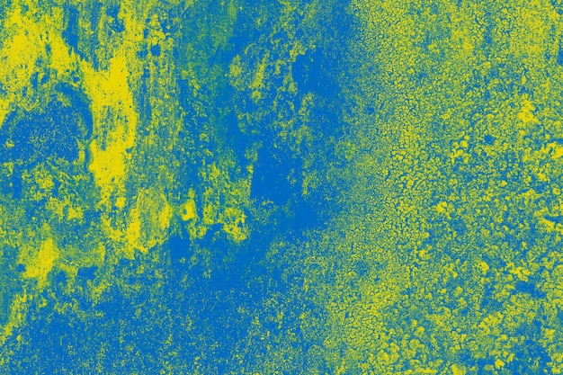 Yellow and blue painted rustic old concrete wall surface for texture background