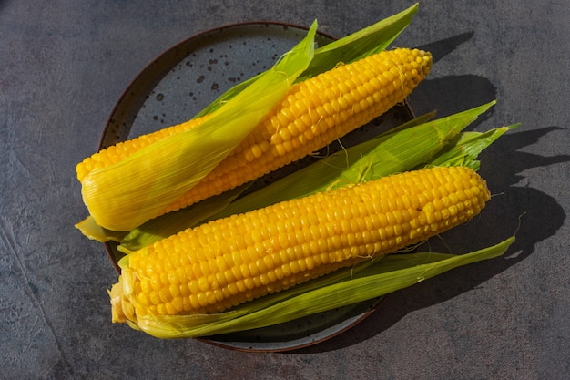 Yellow boiled corn on the cob on a plate