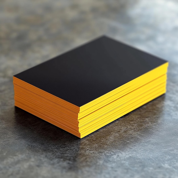 a yellow box with a black square on it sits on a grey surface