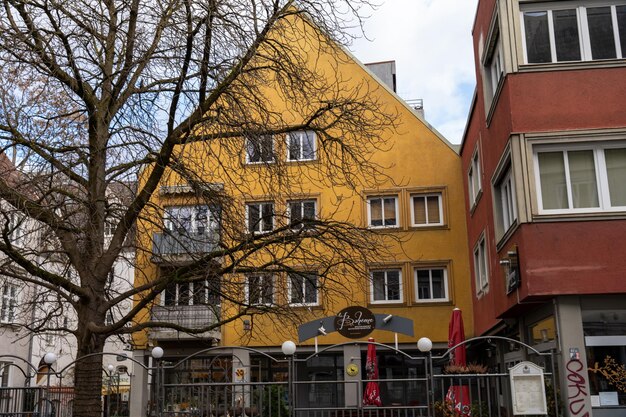 A yellow building with a red roof and a sign that says Welcome on it