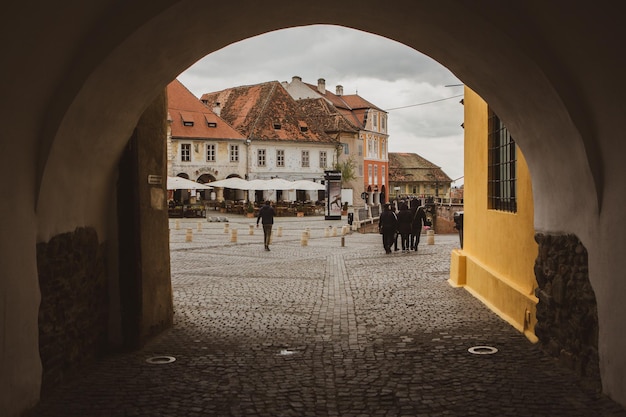 A yellow building with a yellow wall and a sign that says'the word brasov '