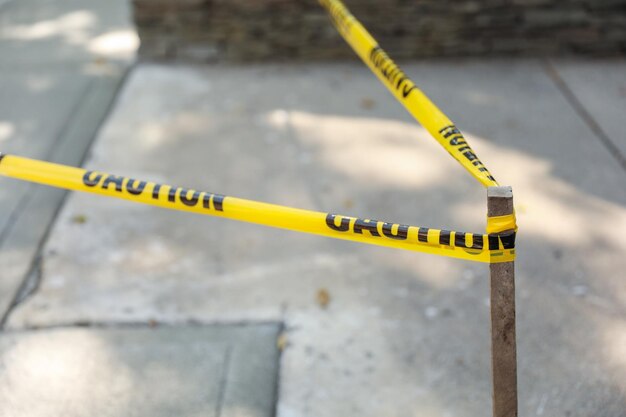 Yellow caution tape on streets symbolizes danger restriction and safety measures warning of hazar