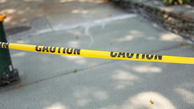 Yellow caution tape on streets symbolizes danger restriction and safety measures warning of hazar