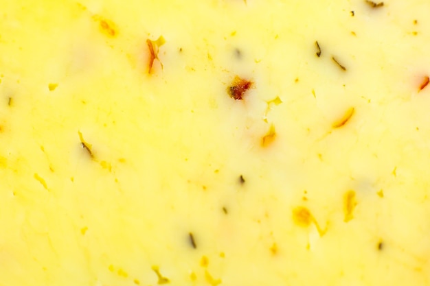 Yellow cheese with herbs and spices background Texture Close up macro photo