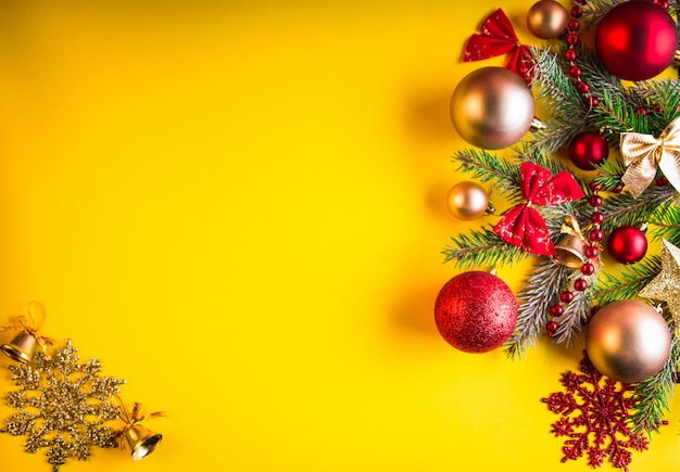 Yellow Christmas background decorated with fir tree and toys