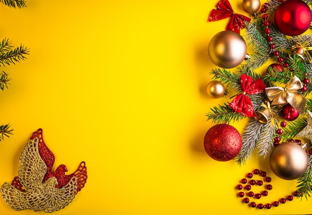 Yellow Christmas background decorated with fir tree and toys