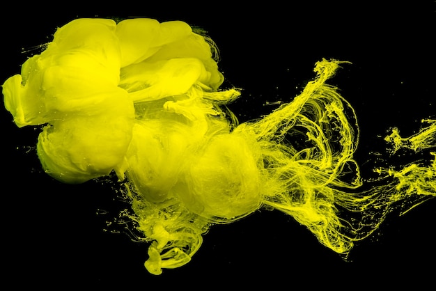 Yellow cloud of acrylic ink.Color drops in water.