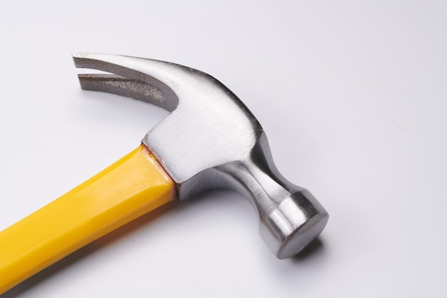 Yellow construction hammer isolated on white background closeup