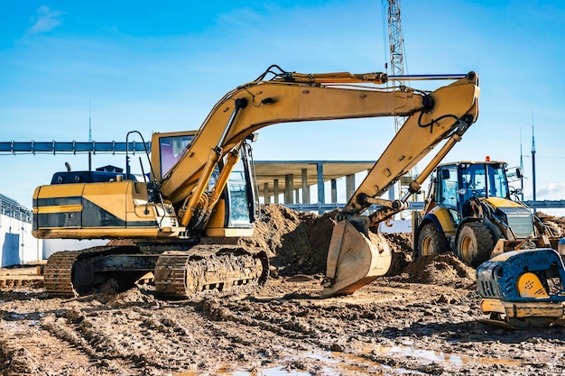 Yellow crawler excavator at the construction site Earthworks at a construction site Modern earthmoving equipment