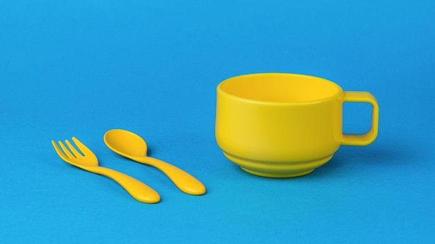 A yellow cup with a handle and a yellow fork and spoon on a blue background