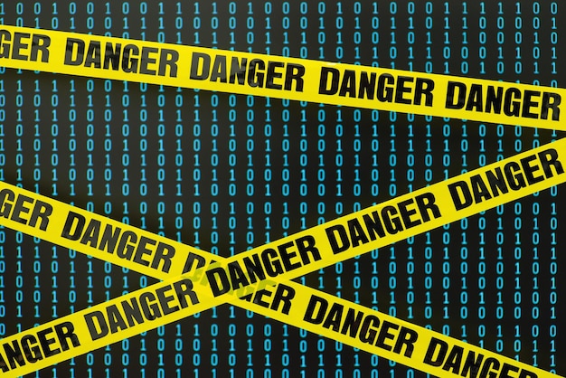 Yellow Danger tape in front of computer screen with 0 and 1 digits Concept of digital security cyber attack information