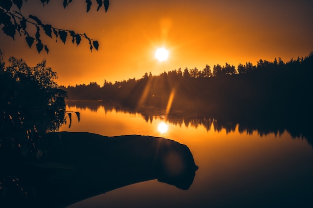 Yellow dawn over a lake in a flooded quarry, Romance mountains