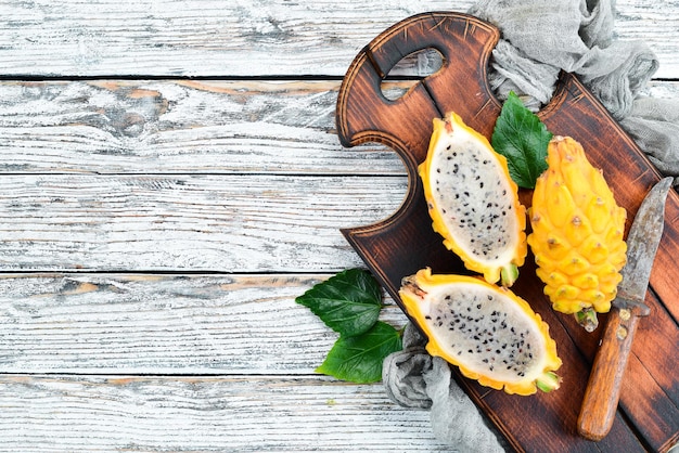 Yellow Dragon Fruit on a white wooden background Pitahaya Tropical Fruits Top view Free space for text