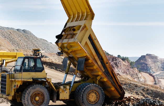 Yellow dump truck lifted in the mine