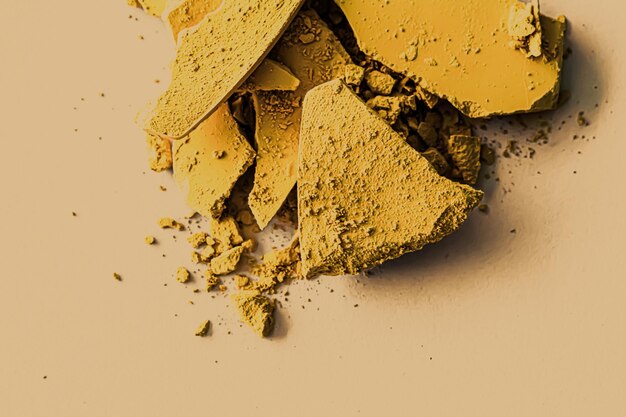 Yellow eye shadow powder as makeup palette closeup crushed cosmetics and beauty texture