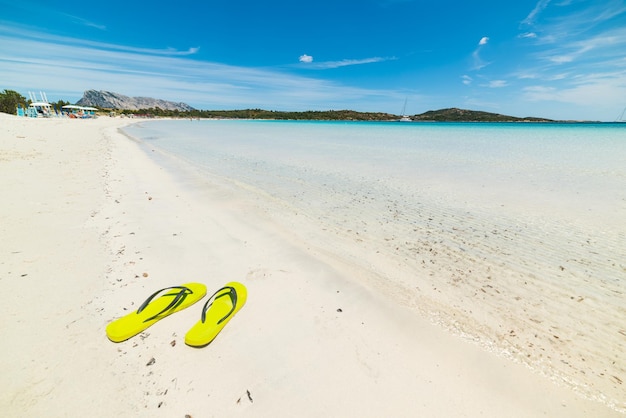 Yellow flip flops in Cala Brandinchi Sardinia