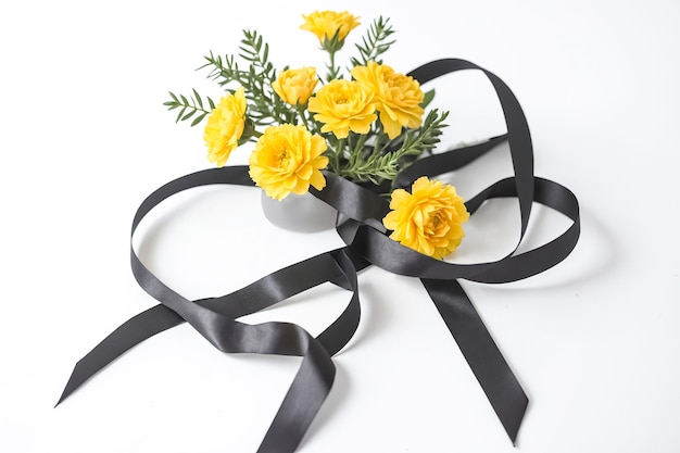 Yellow Flowers and Black Ribbon on White Background