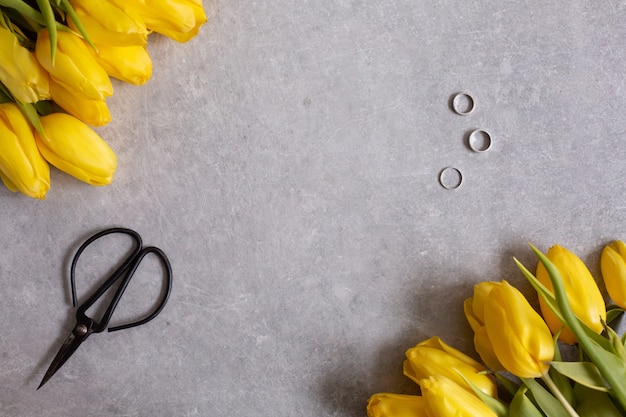 yellow flowers tulips and scissors top view