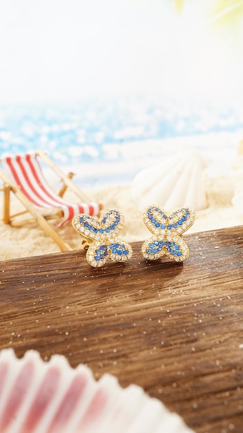 Yellow Gold Diamond Earrings Isolated on beach background